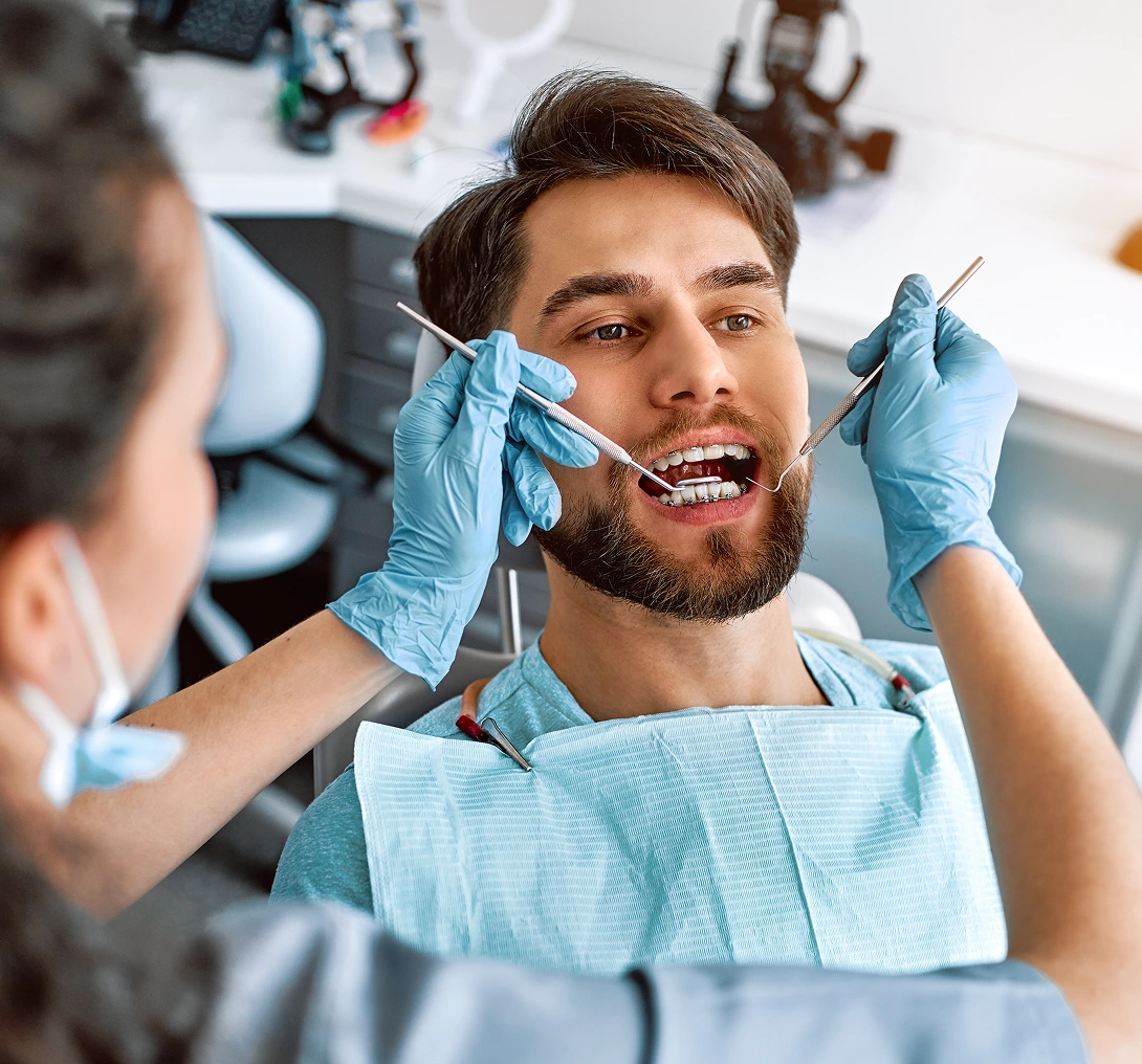 Man receiving dental check-up from dentist.
